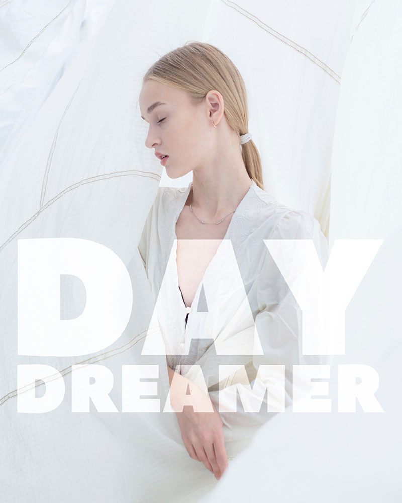 Aesthetic photo of a young woman wearing white on a white background