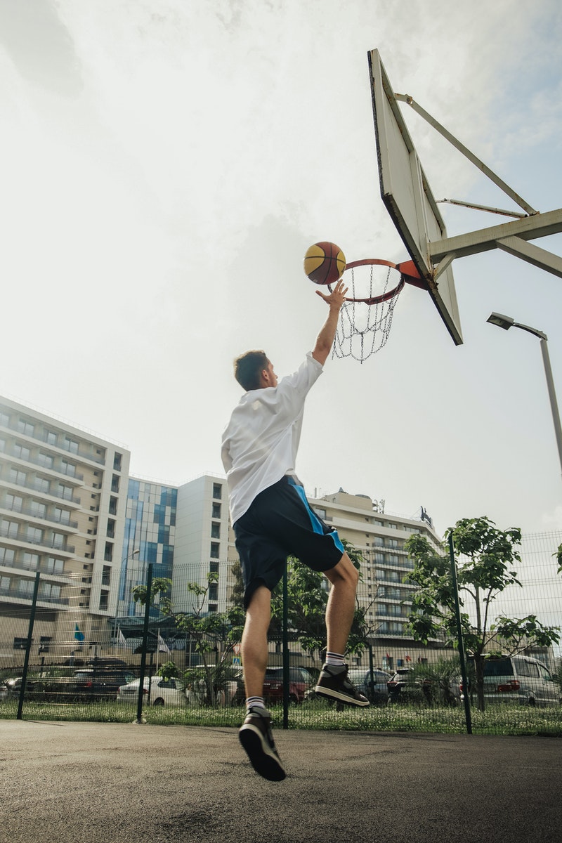 a man scoring a goal in the basket