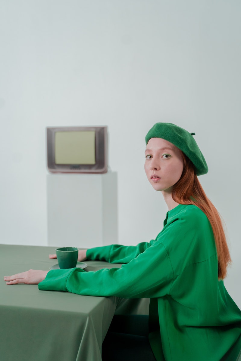 a young woman wearing green jacket