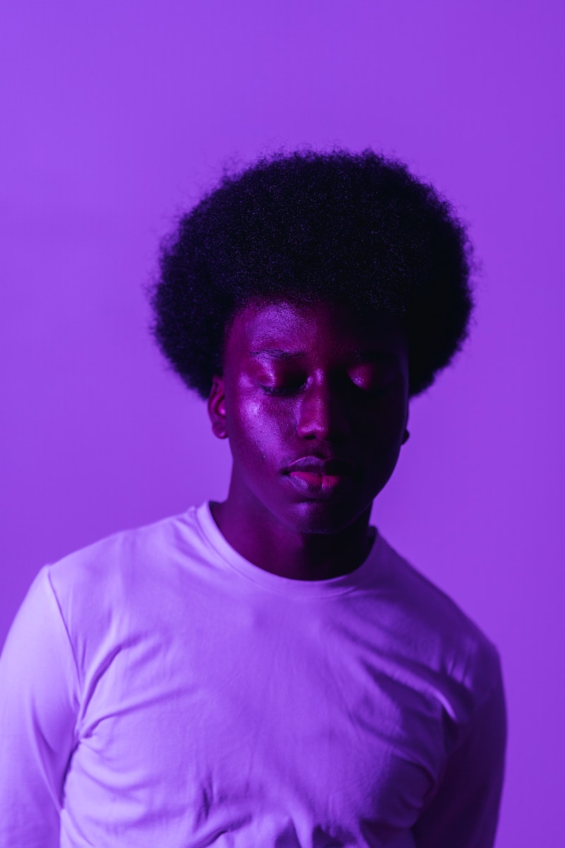 a monochrome purple image of a young man