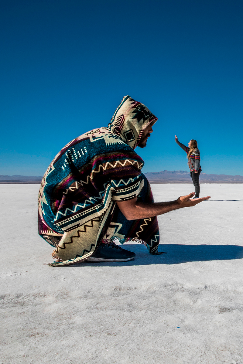 a surreal photo of a man holding a small version of a woman