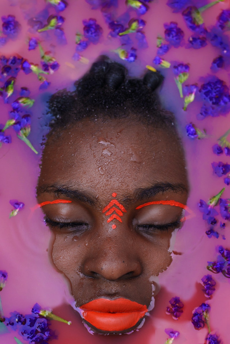a young woman posing over purple background