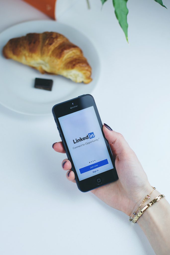 Person using LinkedIn on an iPhone